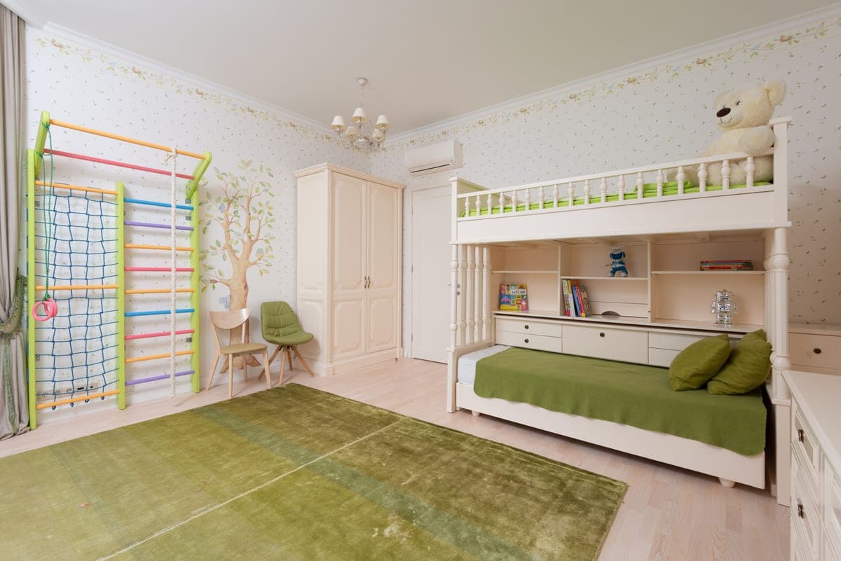 A wooden bunk bed with a ladder in a child's bedroom