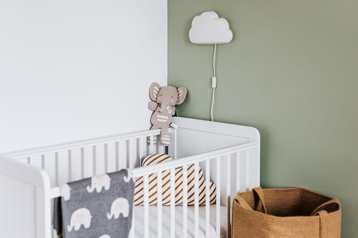 A nursery interior with a white crib