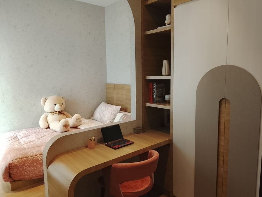 A raised bed above a study area in a teenager's room